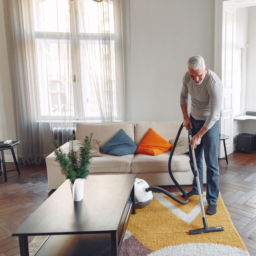 person vacuuming rug